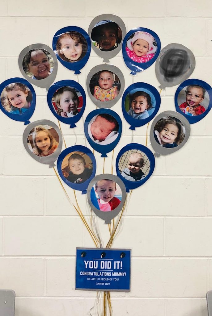 paper balloons with children's faces on them on a wall