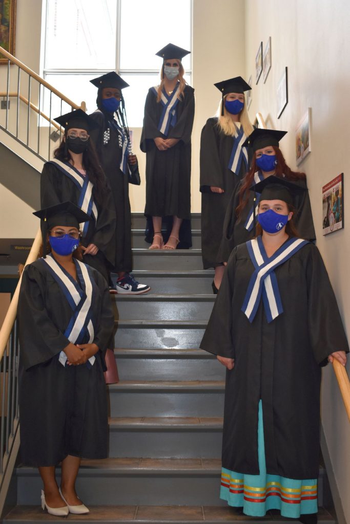 Group photo of young mothers on stairs ready to graduate