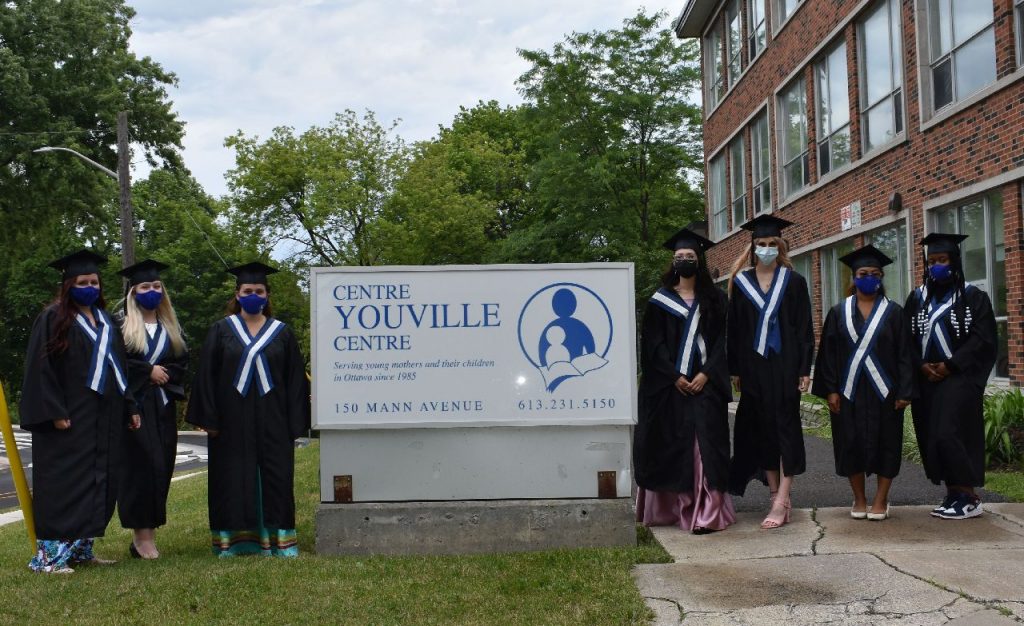 Group photo of young mothers at high school graduation